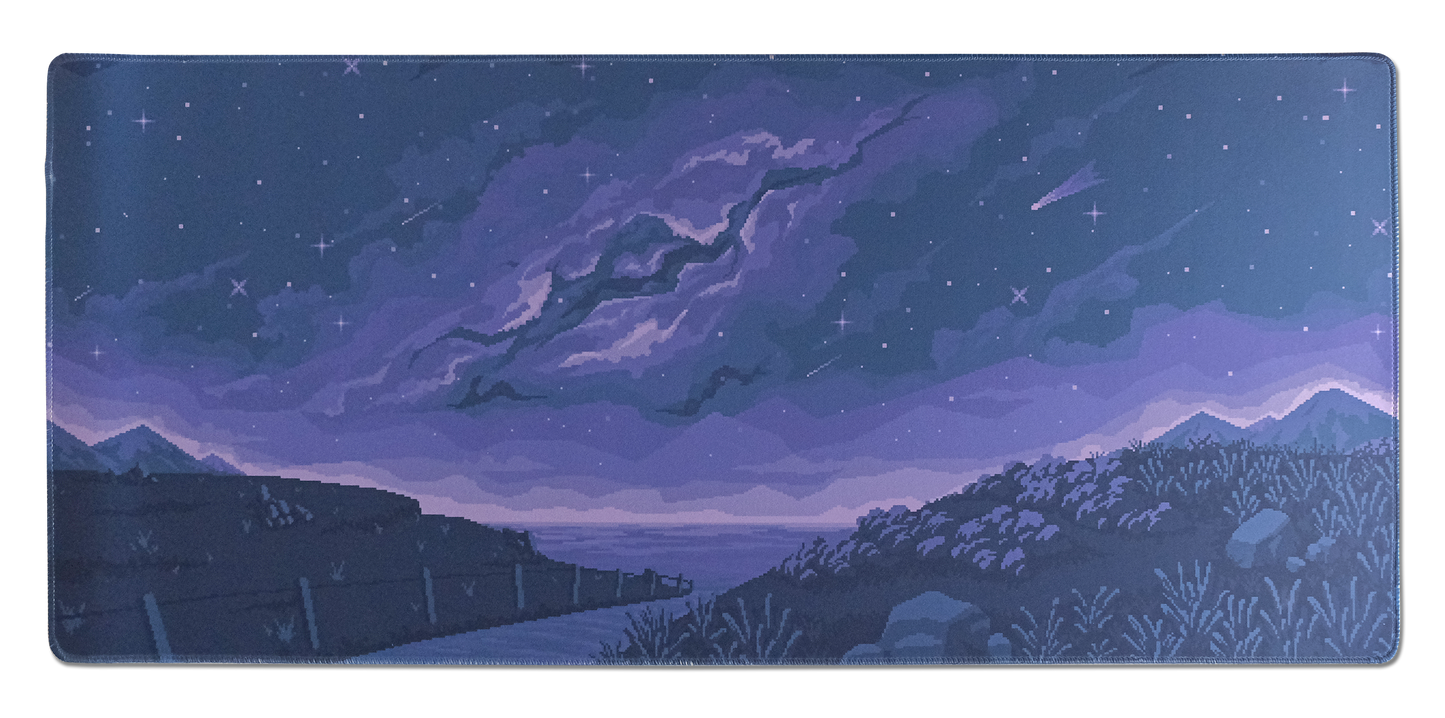 Rectangular desk mat with purple night sky, comet streak, and distant mountains