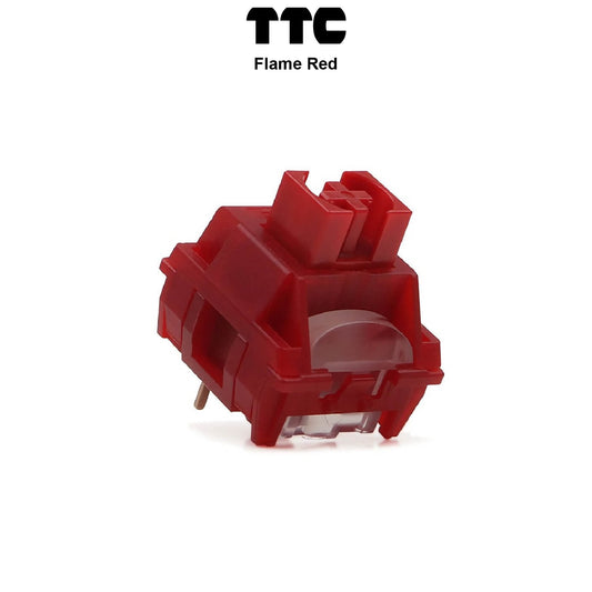 Red mechanical keyboard switch with transparent housing and visible metal pins