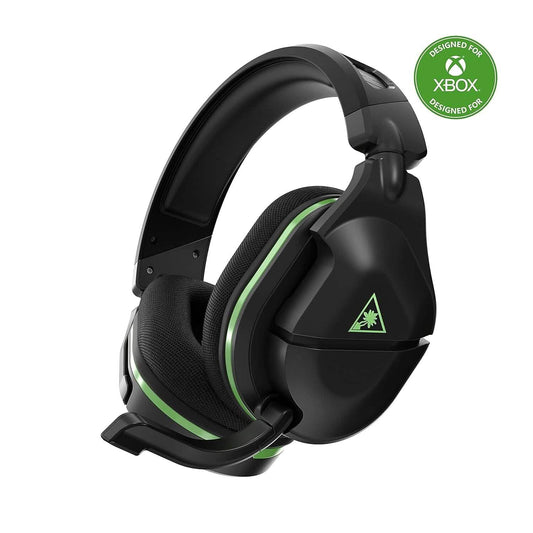 Black wireless gaming headset with green accents and cushioned ear pads