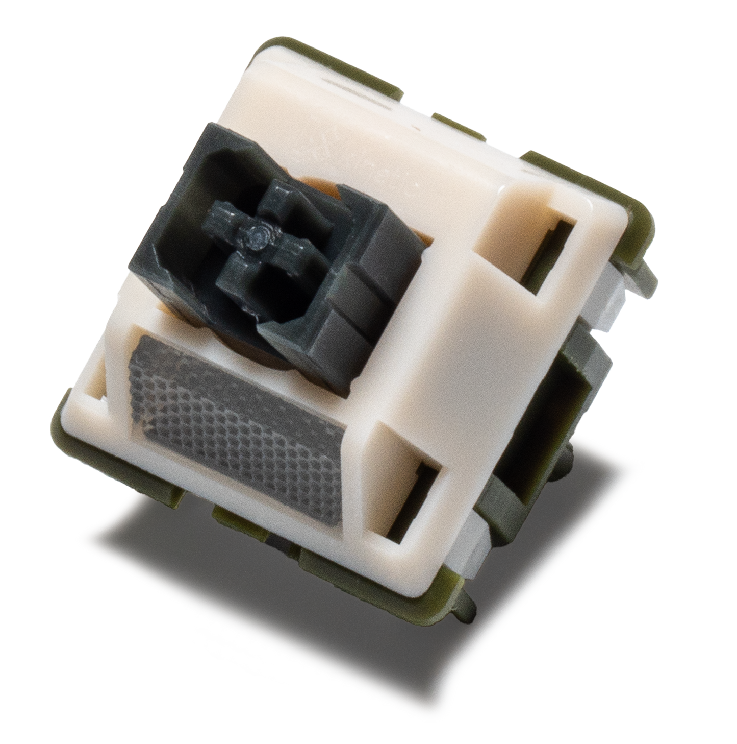 Tactile keyboard switch with cream housing and dark stem, showing the silent contact design