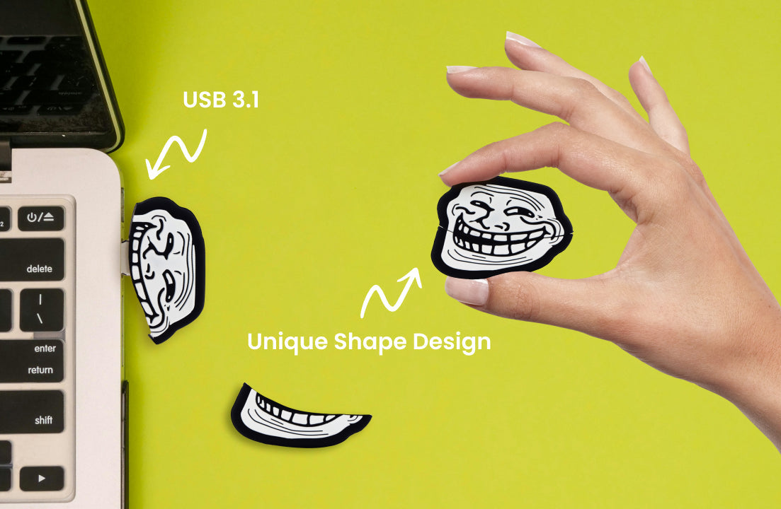 Troll face USB flash drive held in a hand, black body with white graphic and gold tip