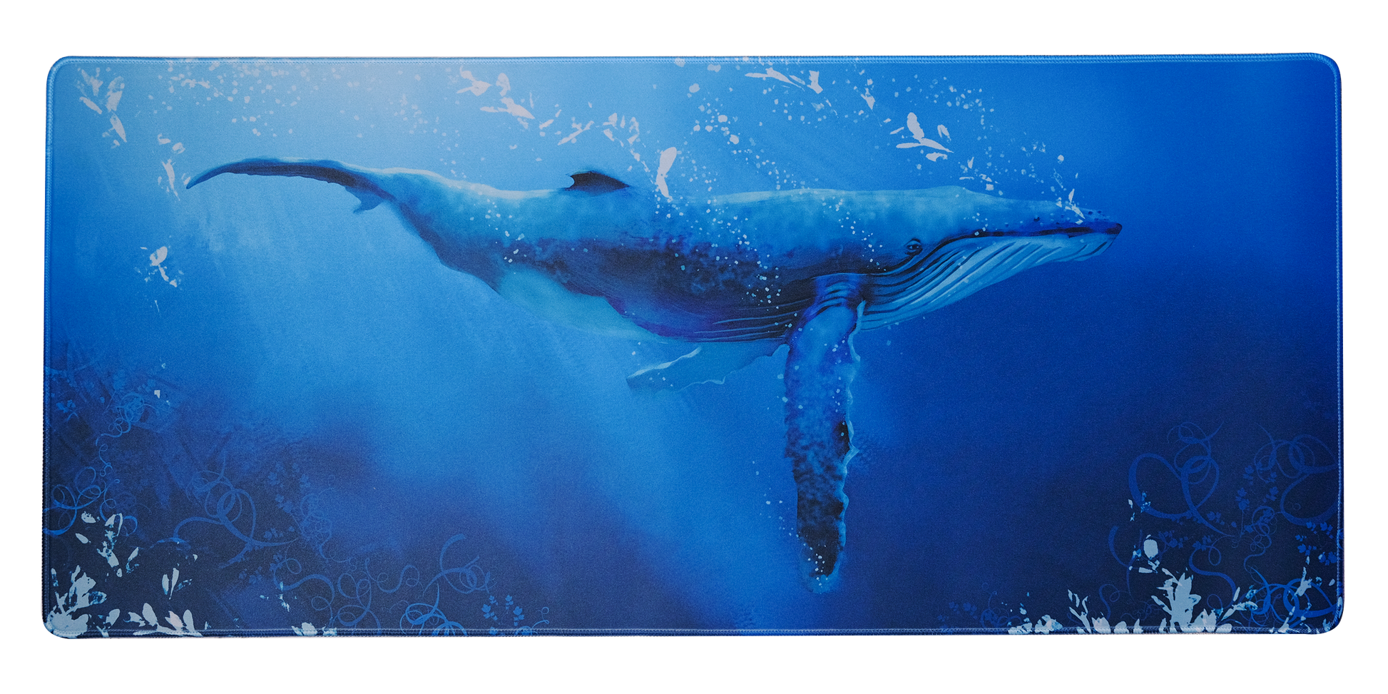 Desk mat with blue whale artwork, speckled water texture, and stitched outline