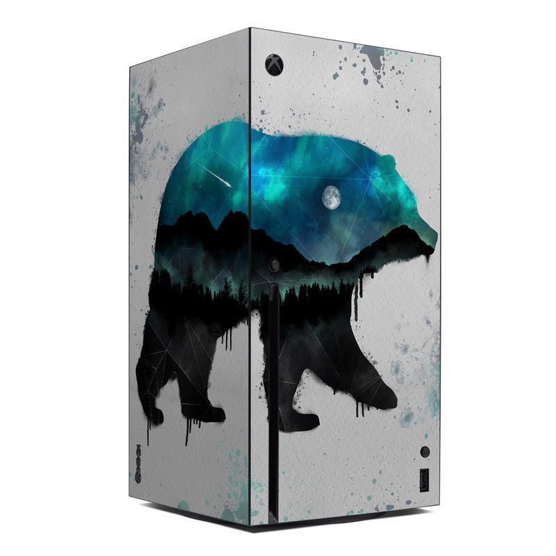 Xbox Series X console skin with blue teal alien-like splatter and forest silhouette graphic