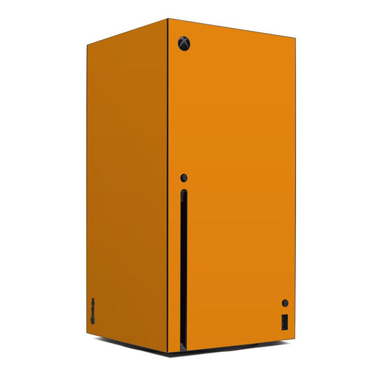 Orange solid Xbox Series X console skin with black vent and button cutouts.